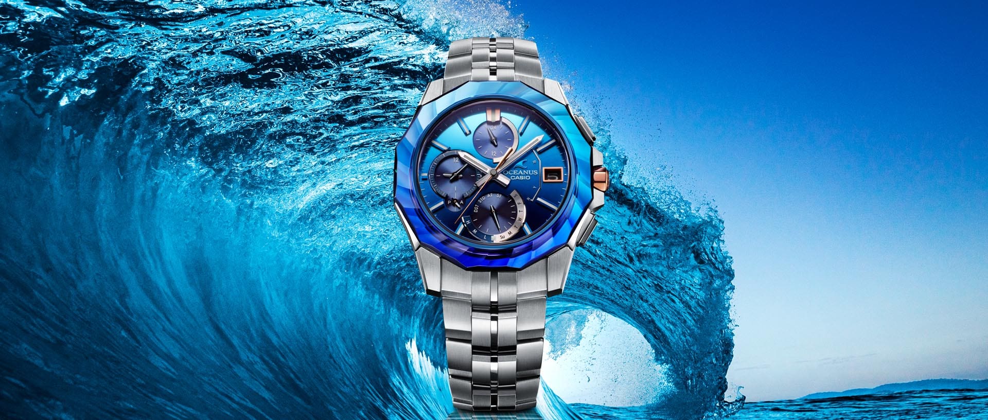 OCEANUS MANTA Series OCW-S6000SW Analog watch with blue bezel in front of a wave