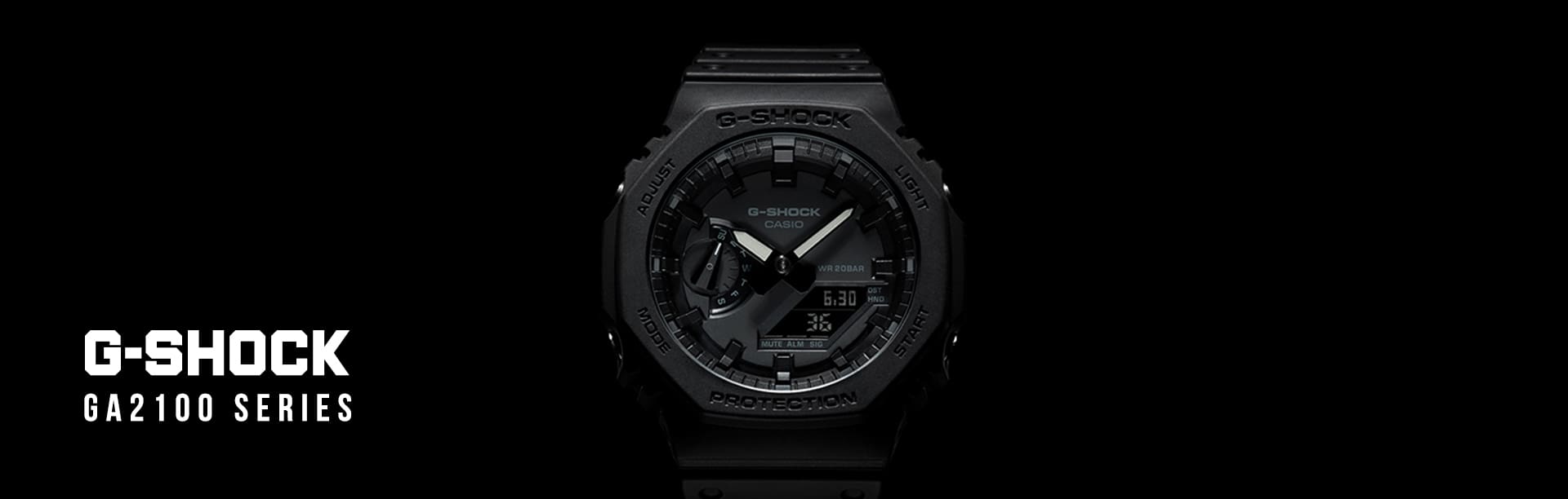 GA2100 black analog digital watch fading away into a black background landscape